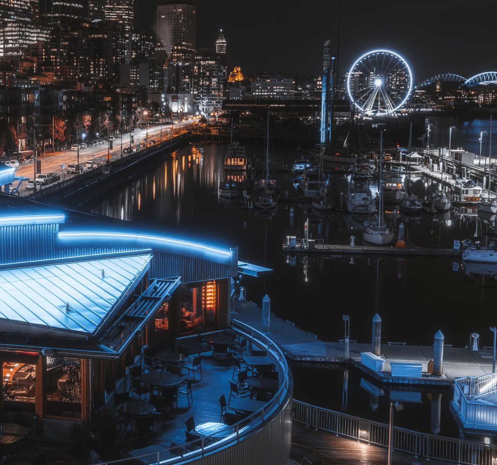 Seattle waterfront marina at night with the city skyline