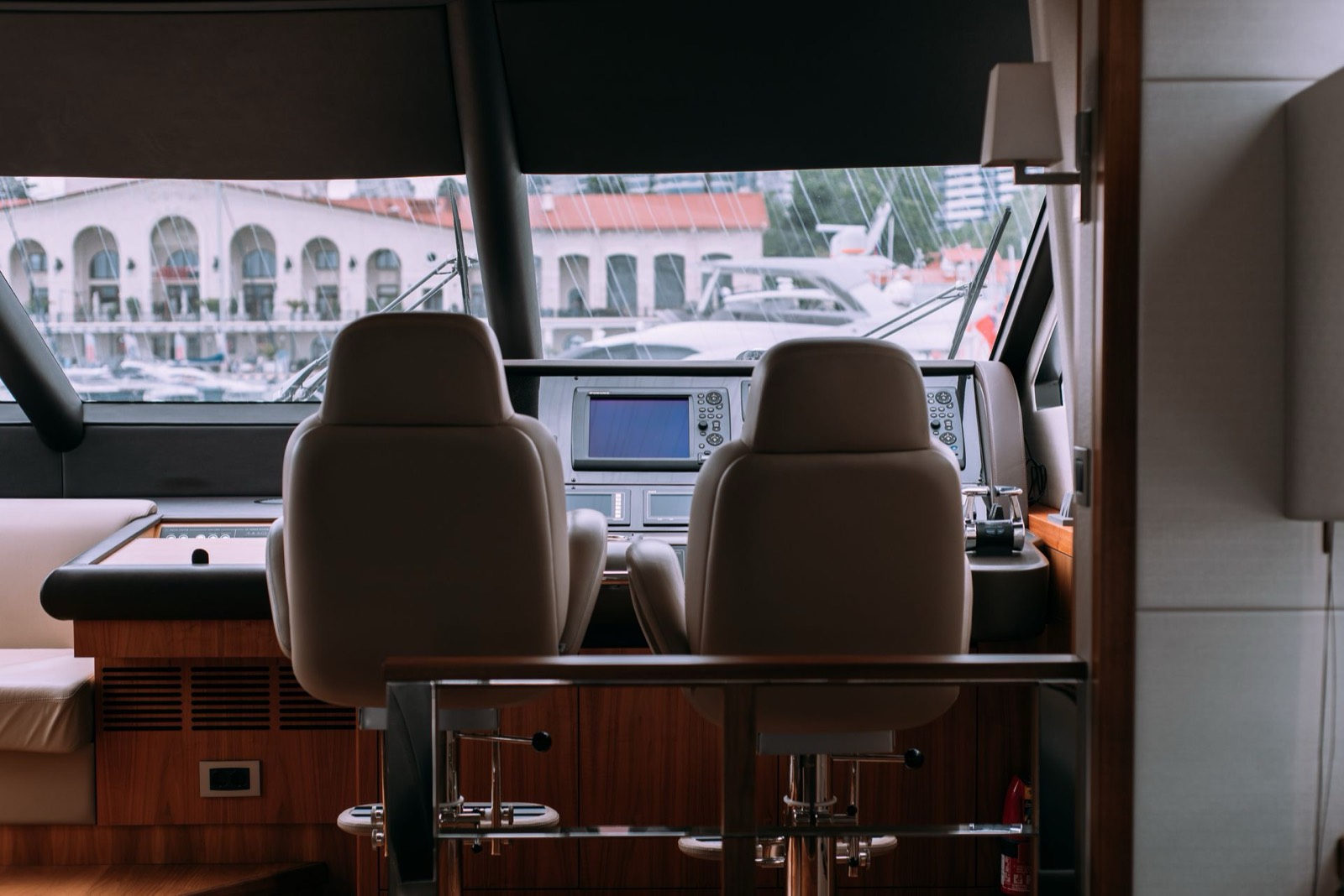 Yacht lower helm with leather seating and teak vent louvers